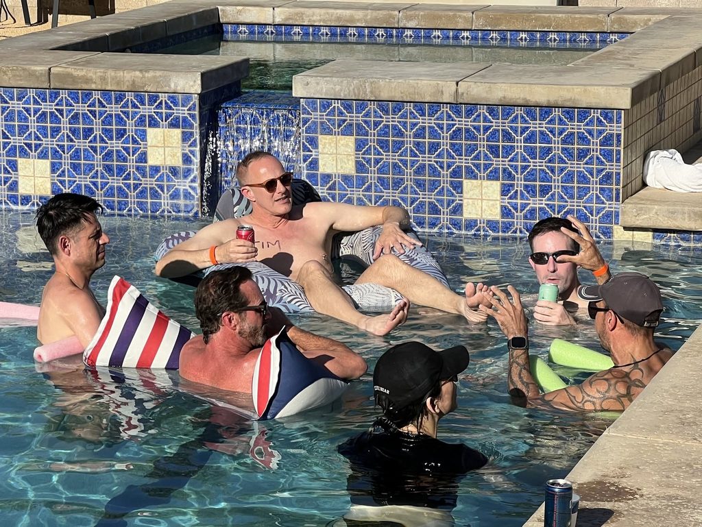 Men in the pool basking in the sun.